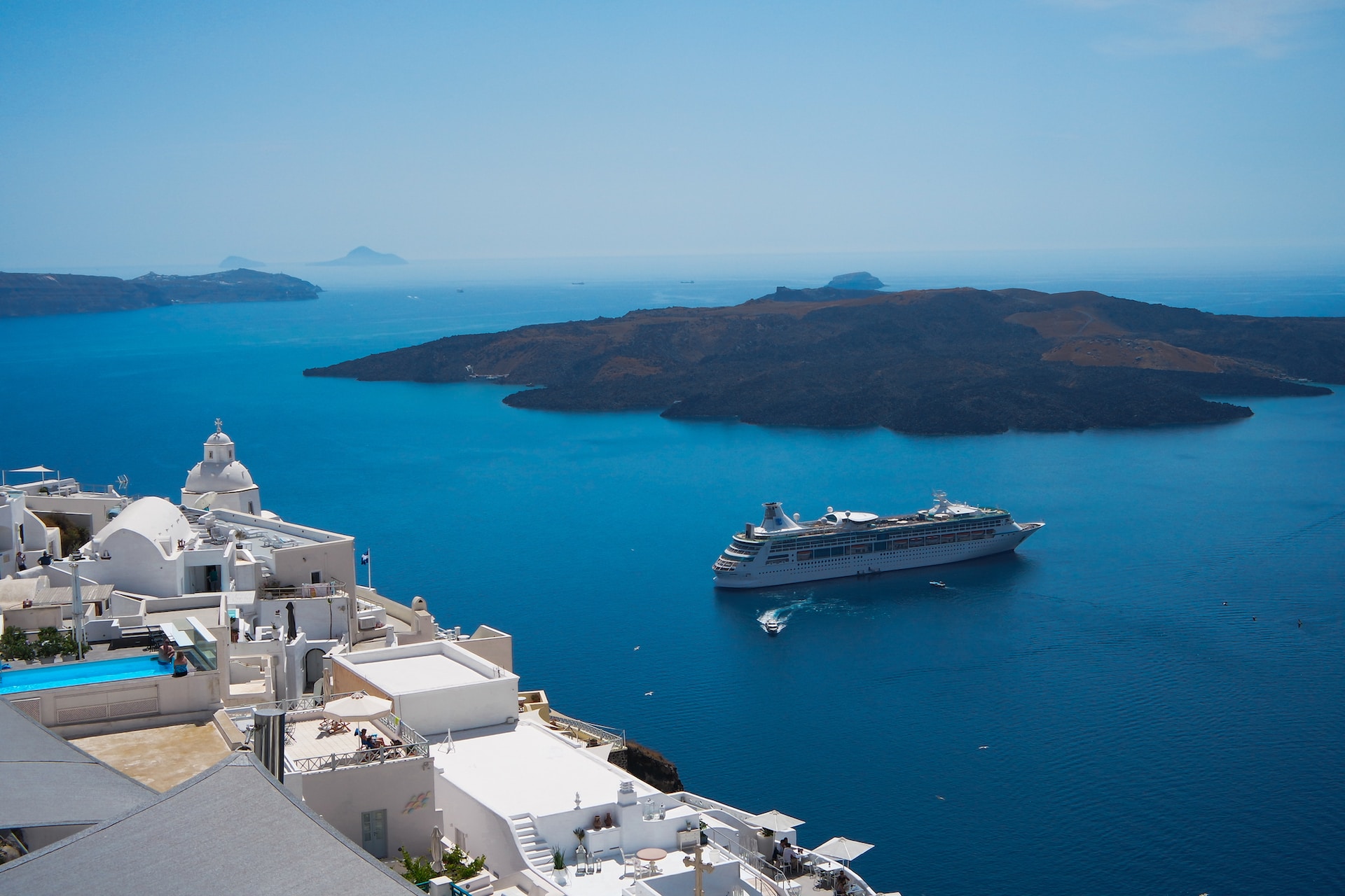 Santorini caldera view with a cruise ship in the background
